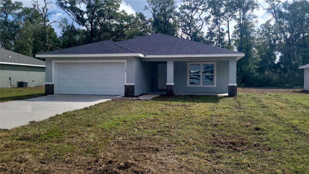 a view of a house with a yard and garage