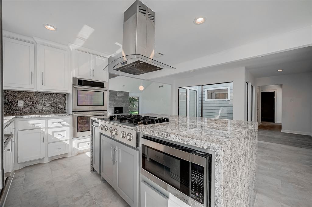 a kitchen with a stove sink and refrigerator