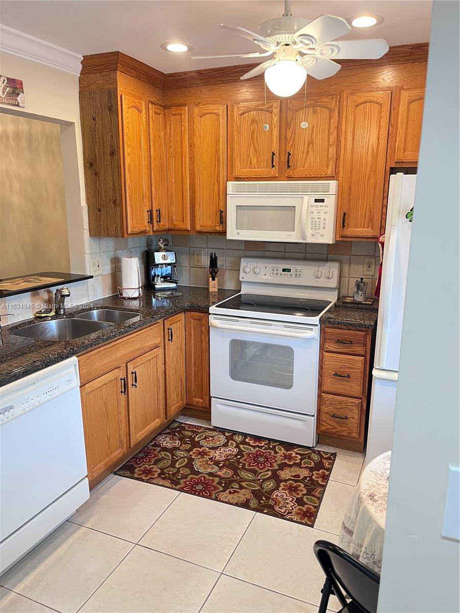 a kitchen with a stove a sink and cabinets