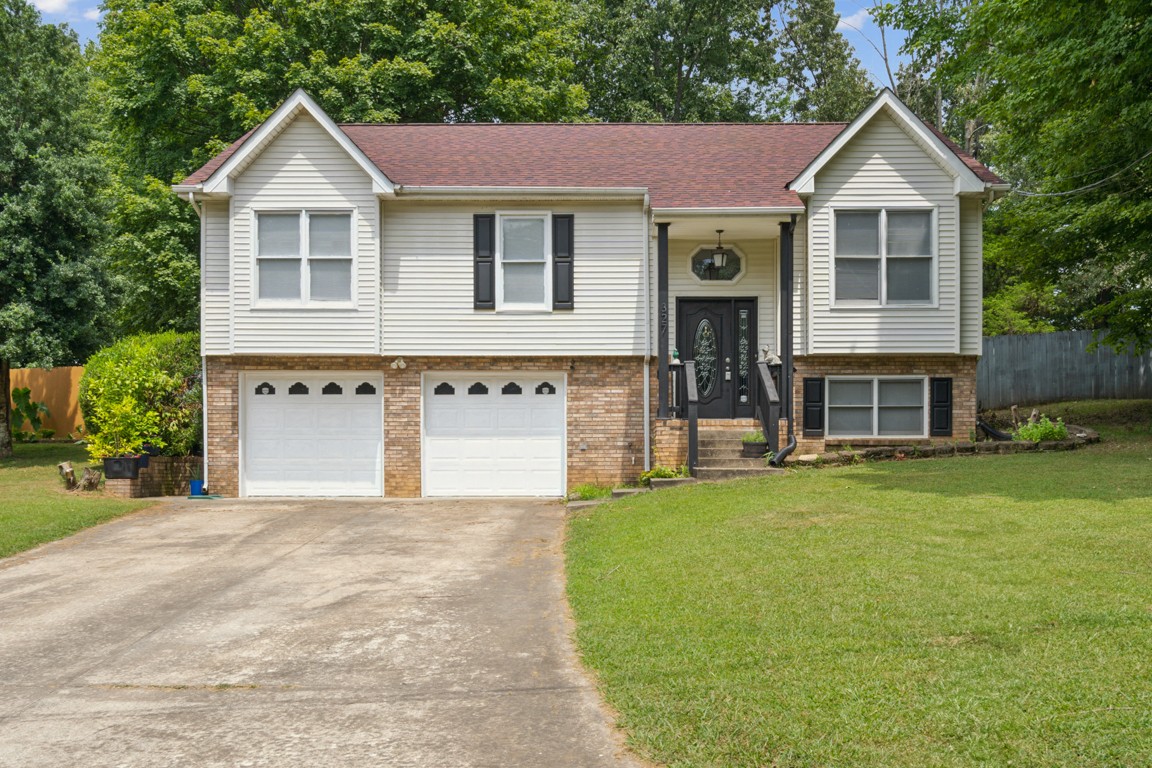 a front view of a house with a yard and garage