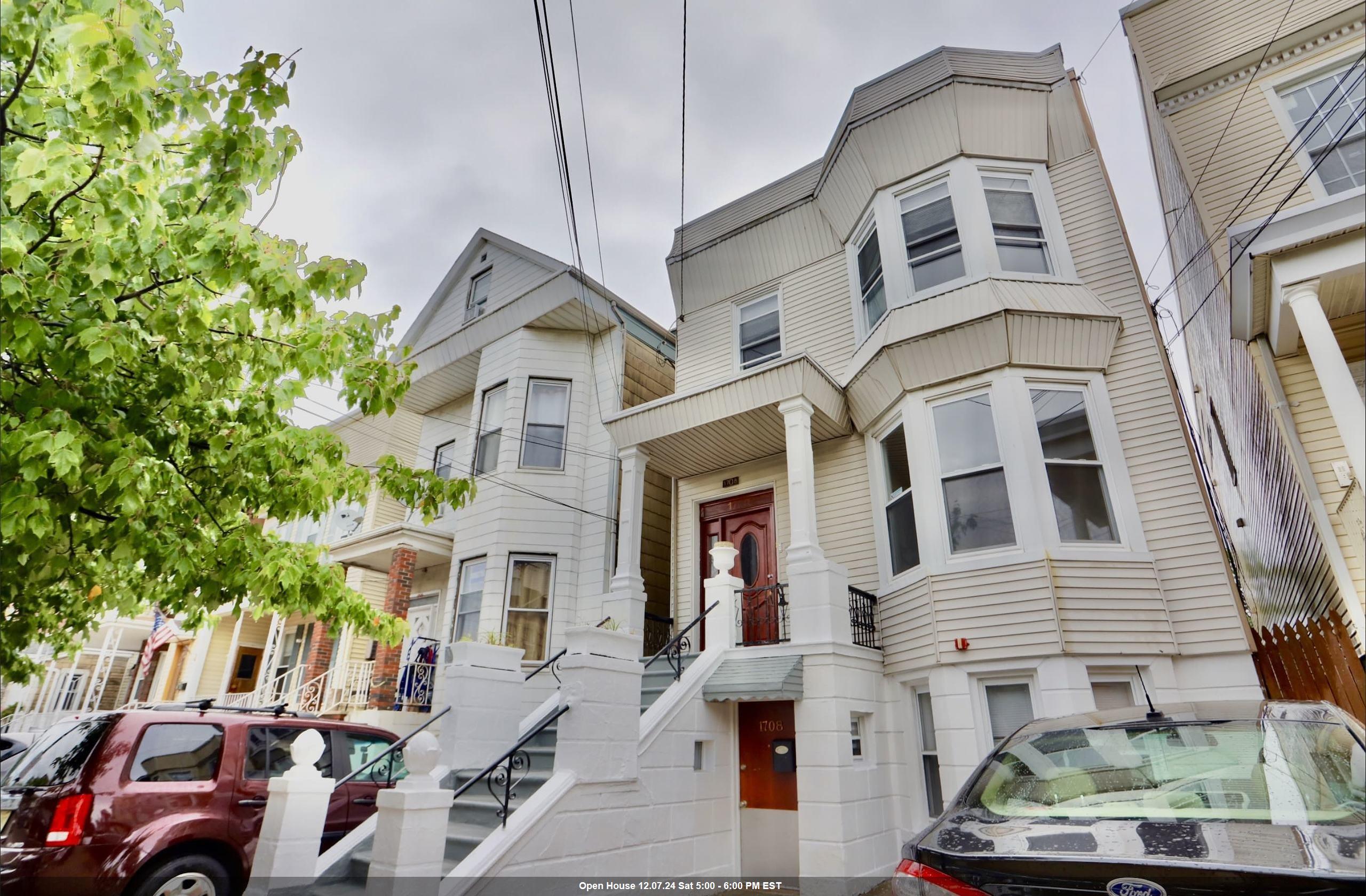 a front view of a residential apartment building with a yard