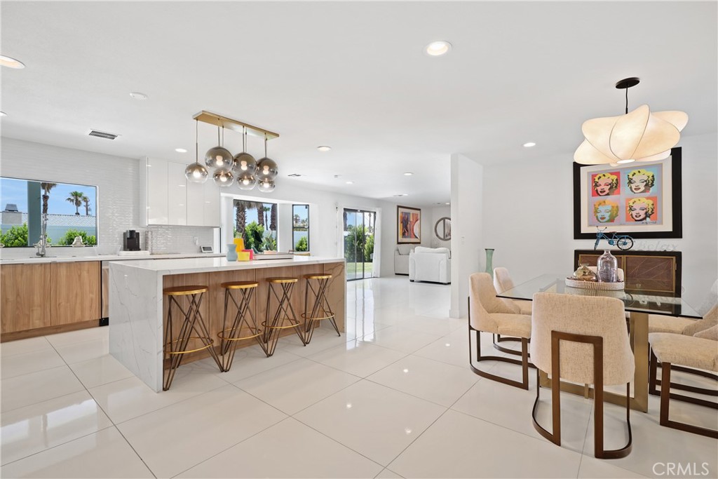 a living room with furniture and a dining table