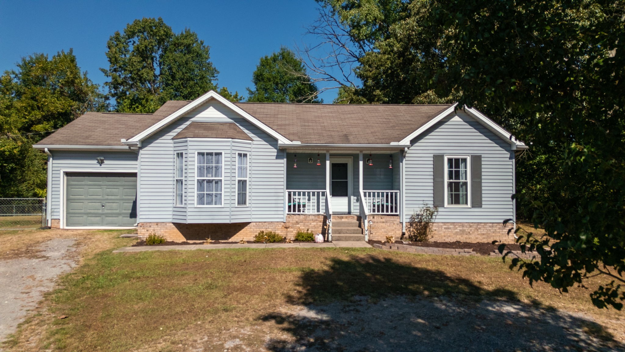 a front view of house with yard and green space