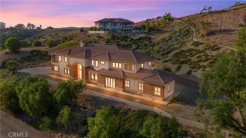 a aerial view of a house next to a yard