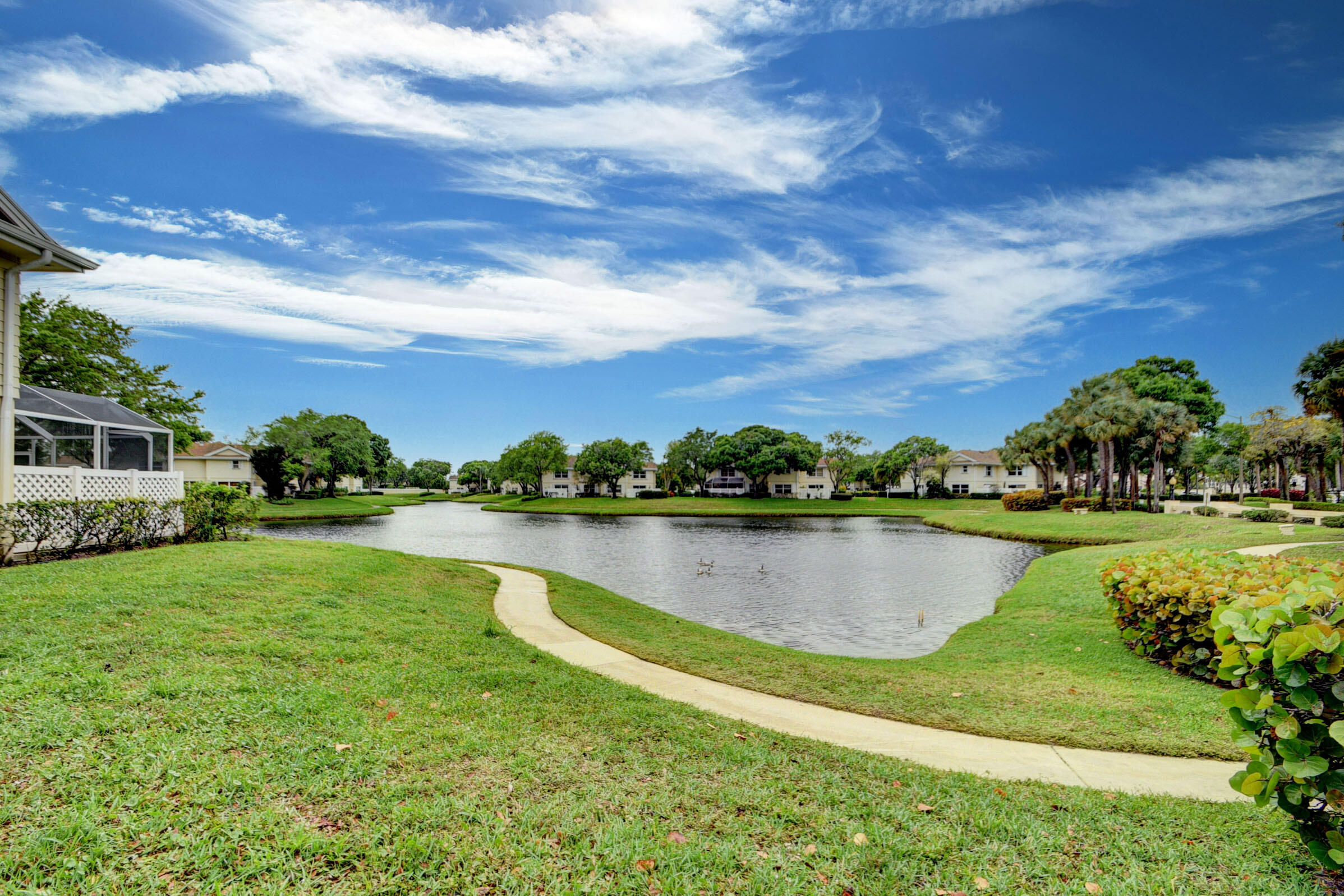 an aerial view of a house with a yard and lake view