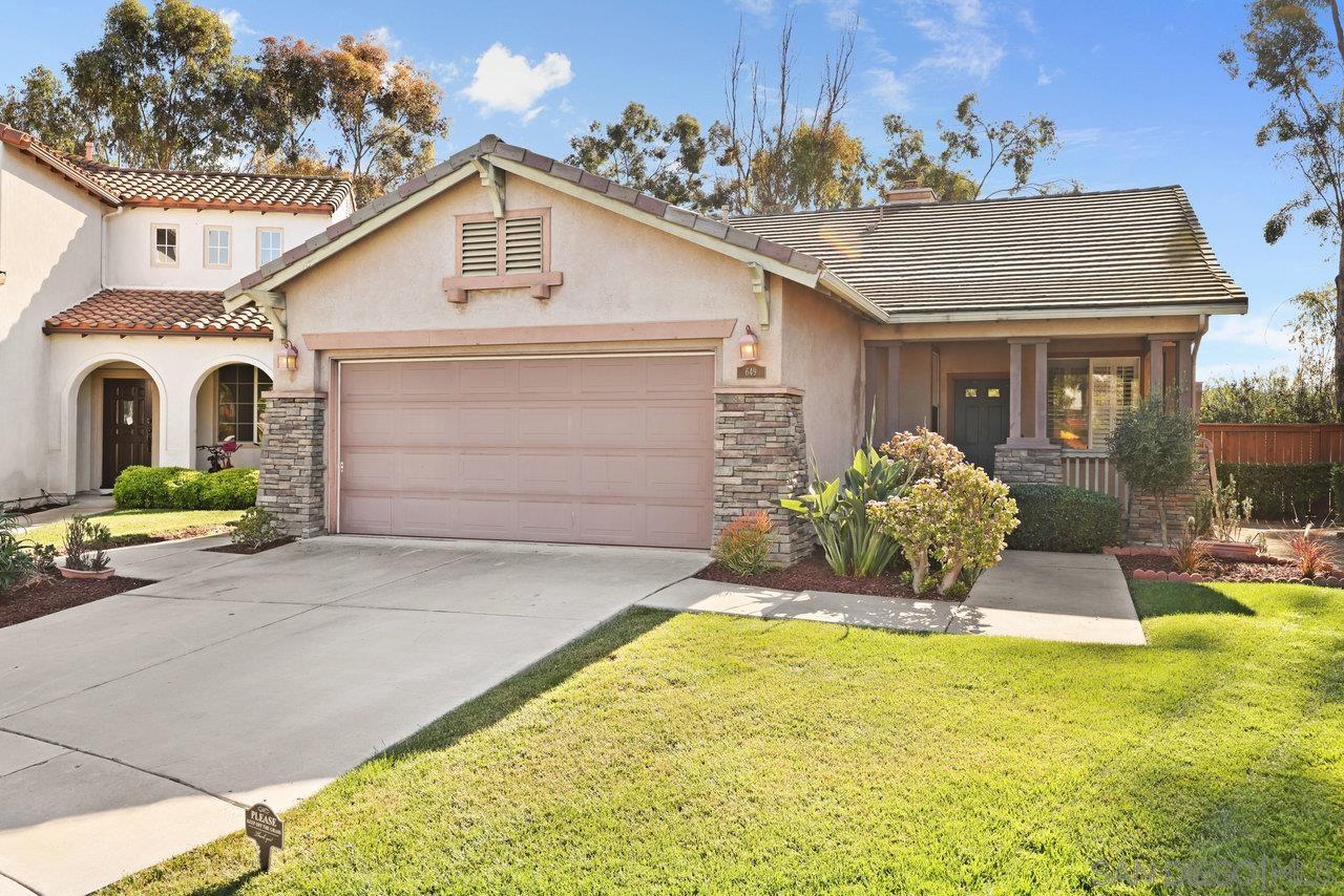 a front view of a house with a yard garage and outdoor seating