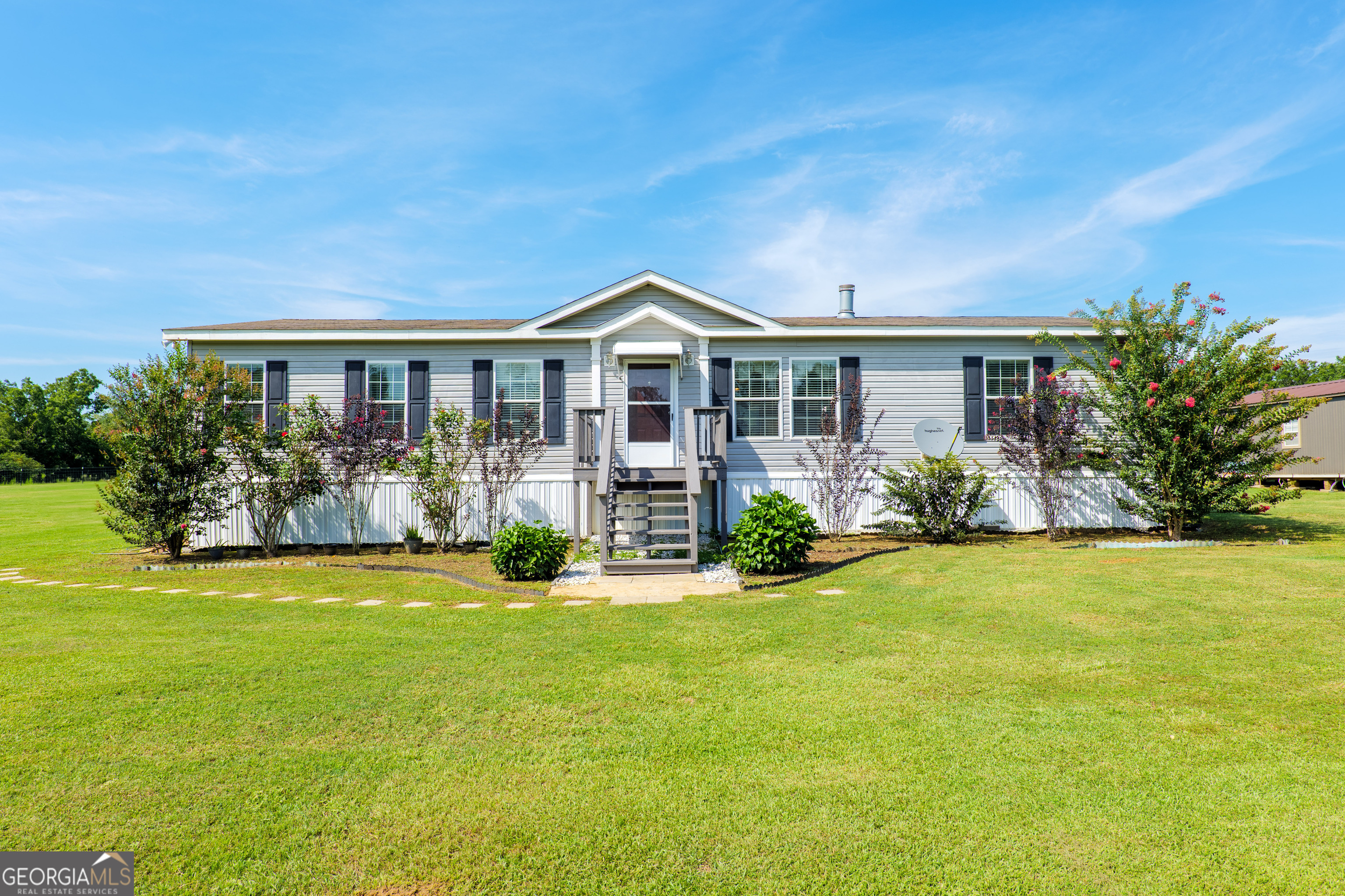 a front view of house with yard and green space