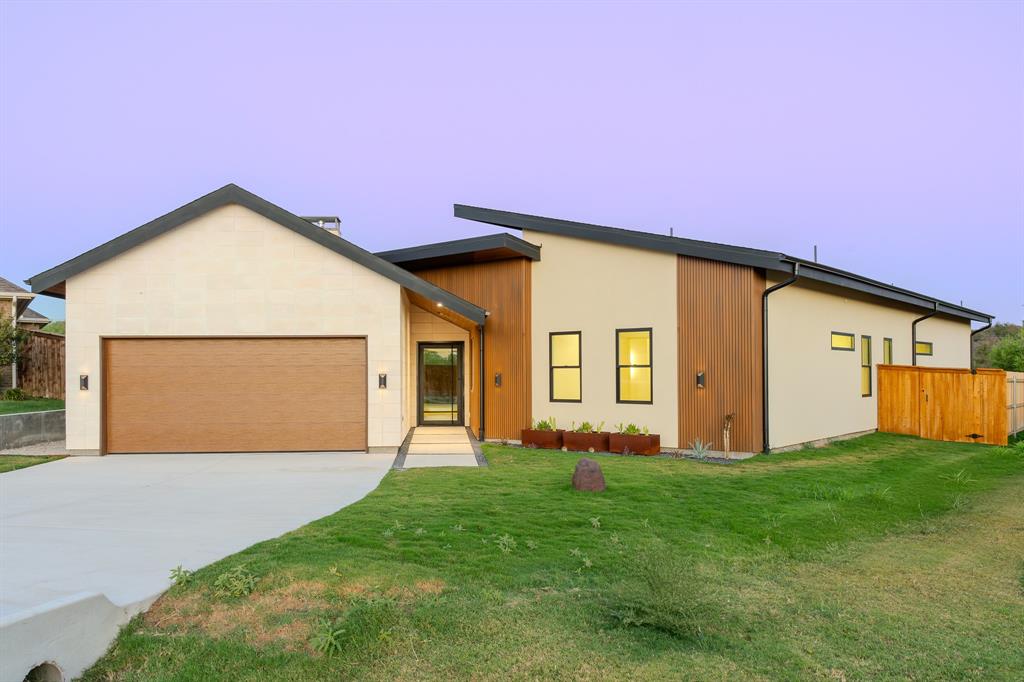 a front view of a house with yard and garage