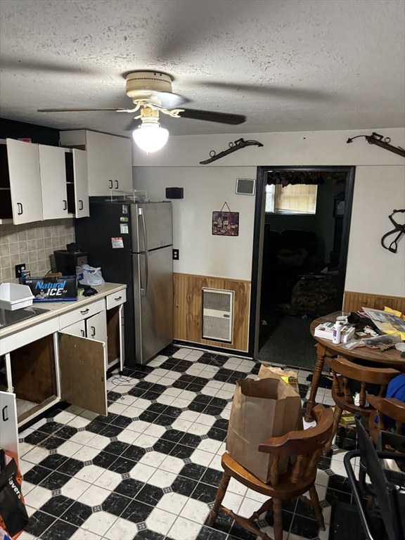 a kitchen with a sink a stove and chairs