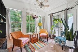 a living room with patio furniture and a large window