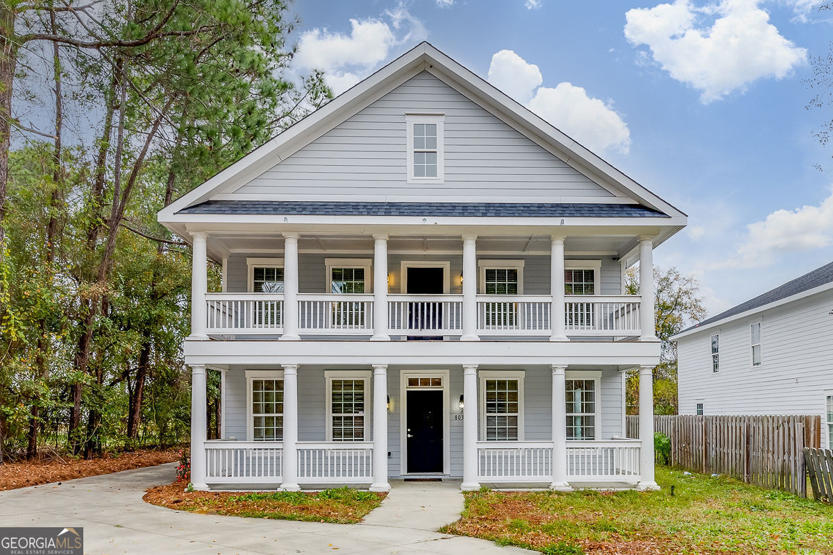 a front view of a house with a garden