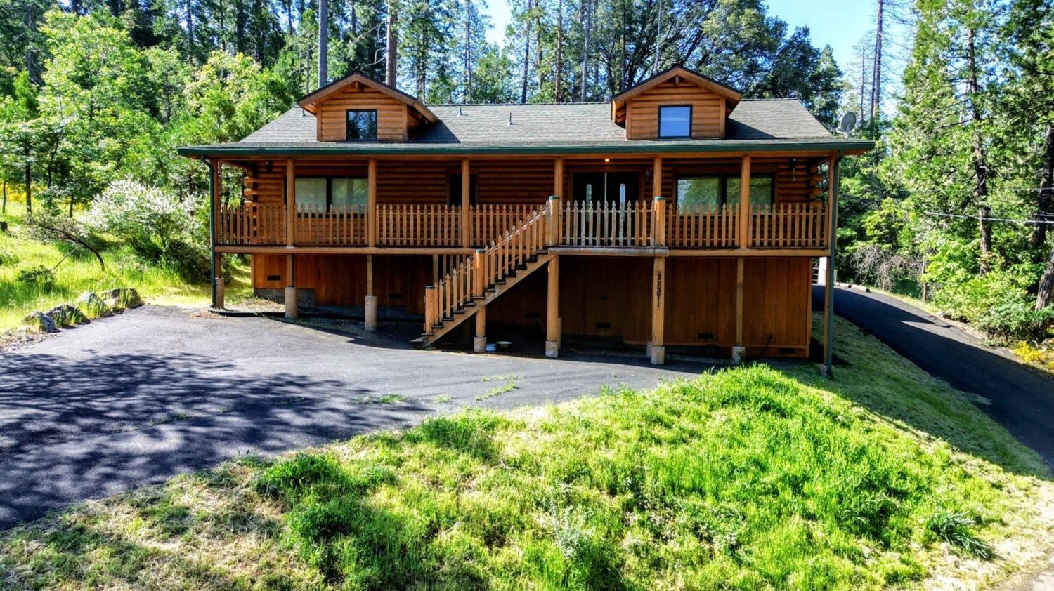 a front view of a house with a yard and balcony