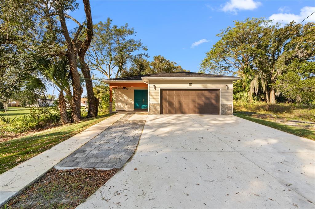 a view of a house with a yard and tree s