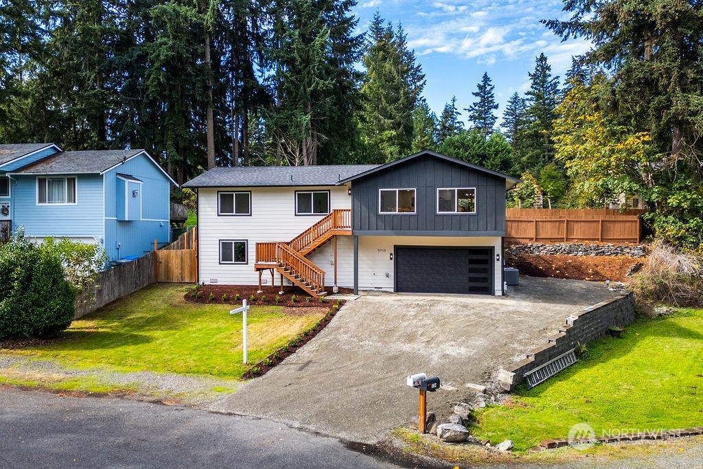 a view of a house with pool and a yard