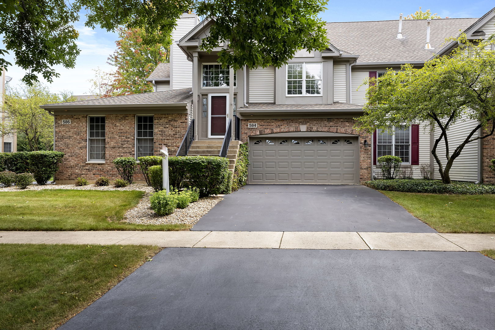 a front view of a house with a yard and garage