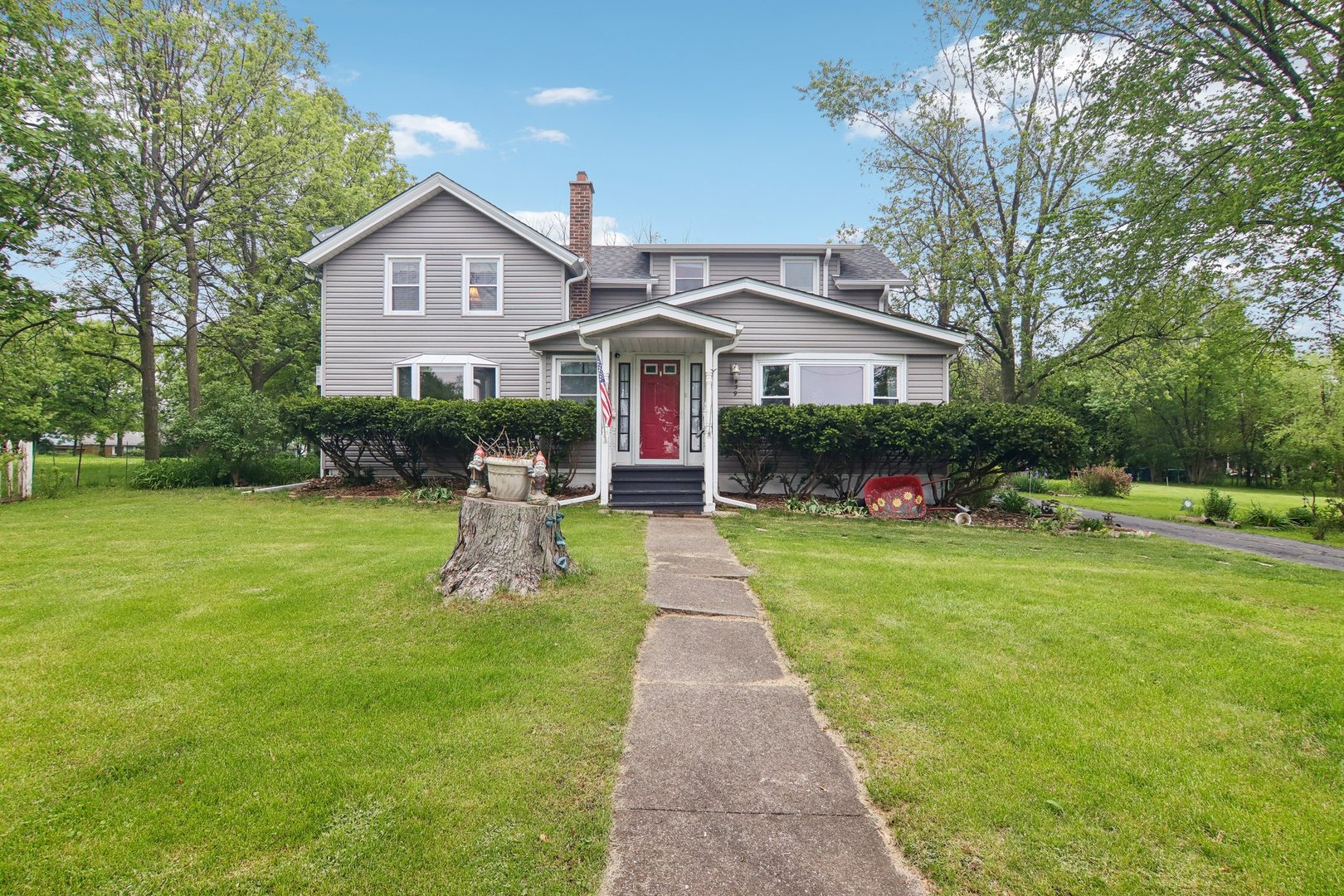 a front view of a house with garden and porch