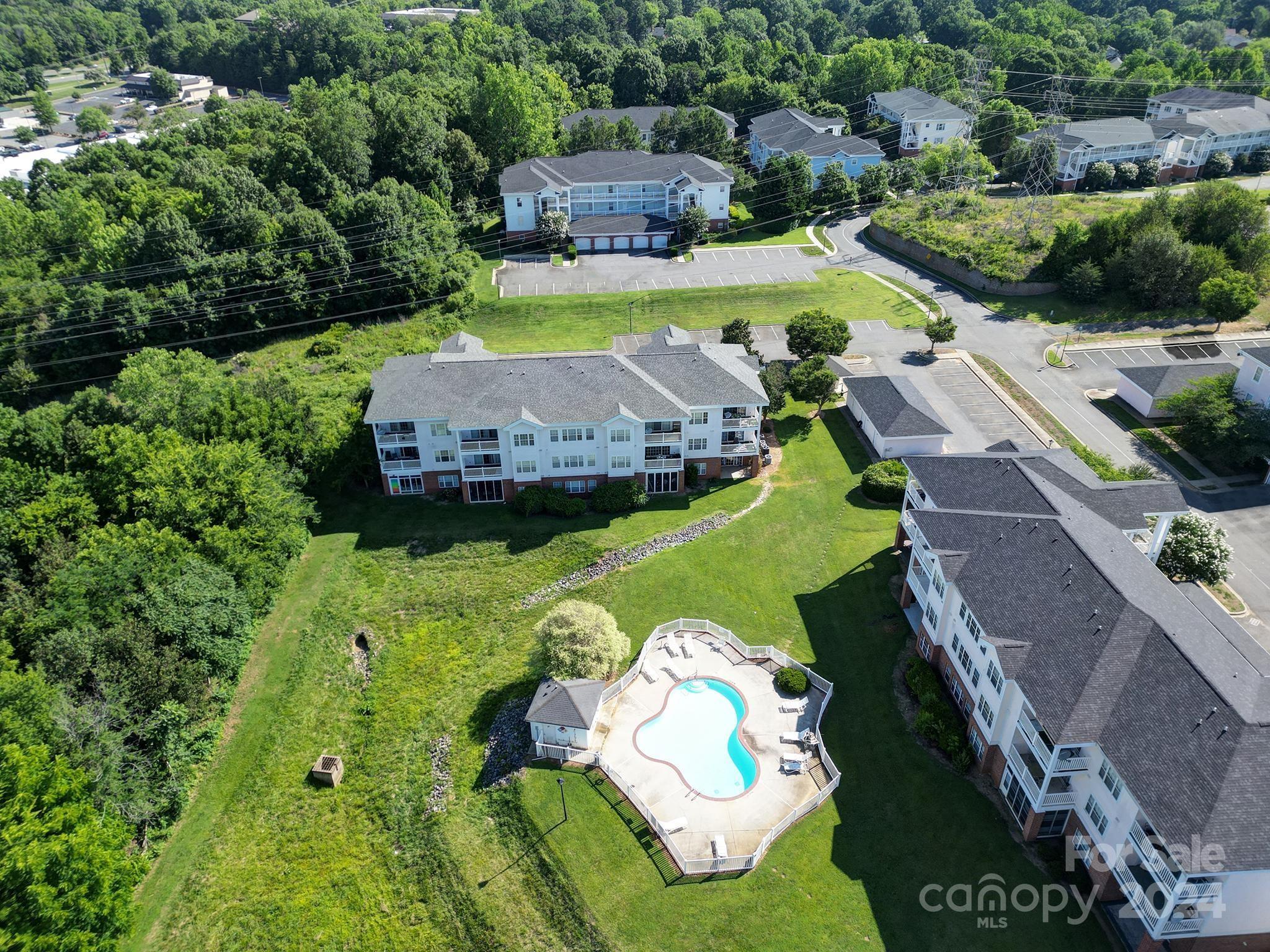 an aerial view of a house with yard swimming pool and outdoor seating