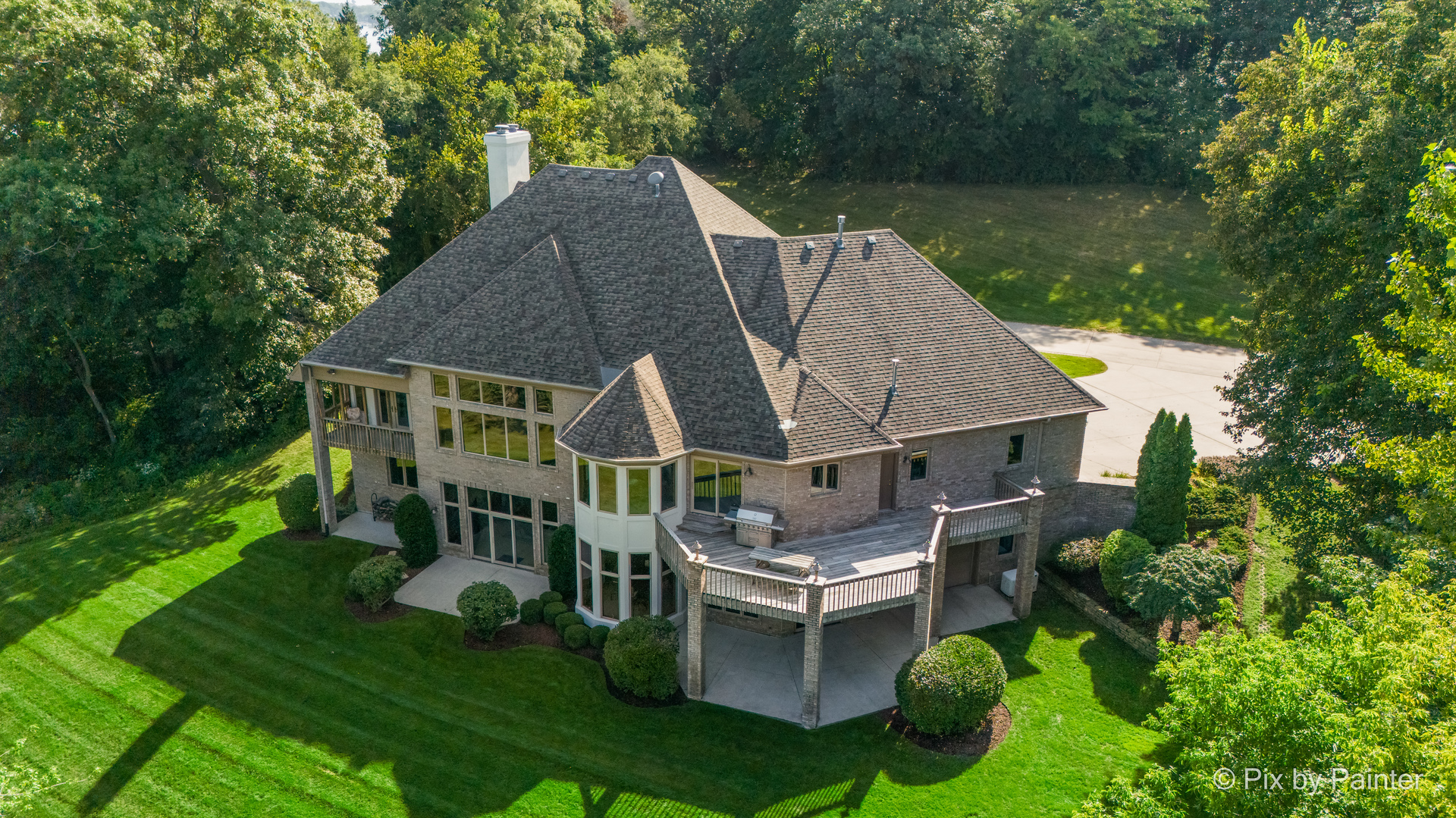 an aerial view of a house having patio with a garden