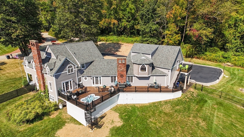 aerial view of a house with swimming pool and sitting area