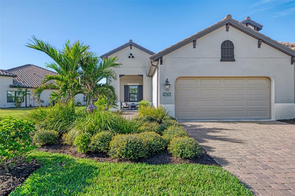 a front view of a house with a yard and garage