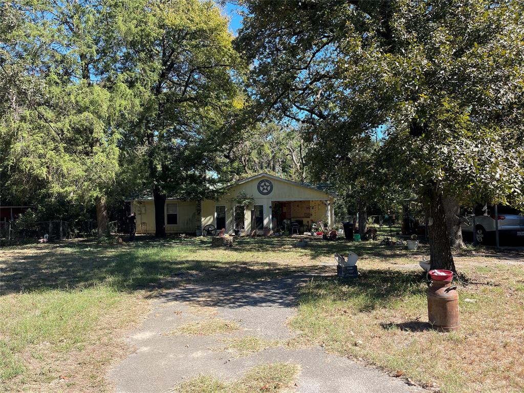 a view of a yard with a house and in the background