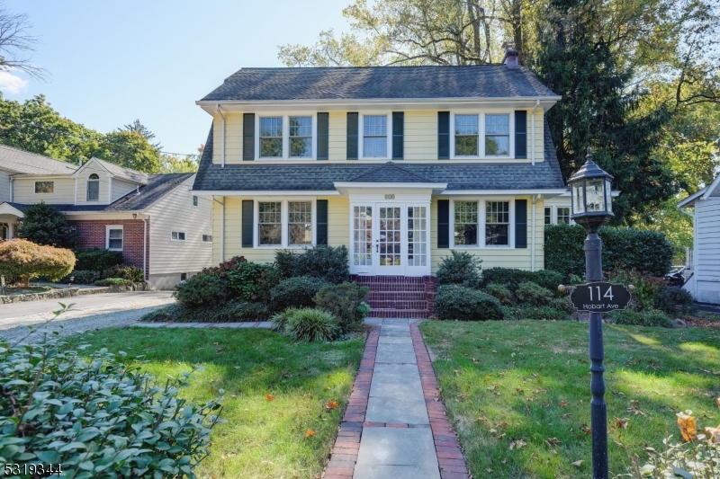 a front view of a house with a yard and porch