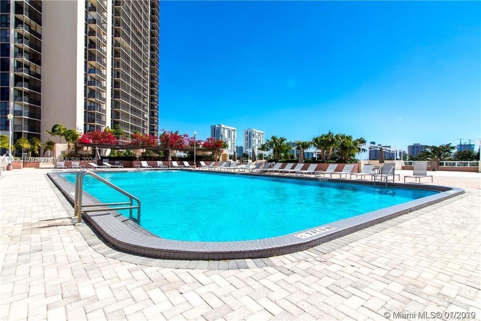 a view of a swimming pool with outdoor seating