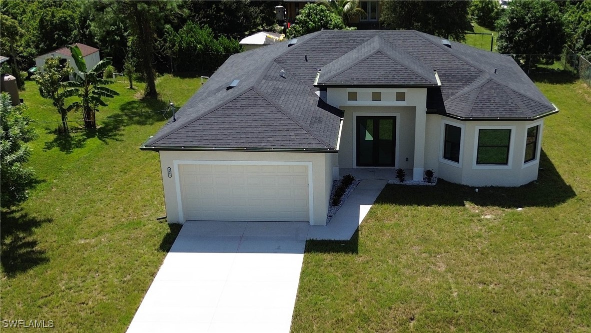 a aerial view of a house with yard barbeque oven and outdoor seating