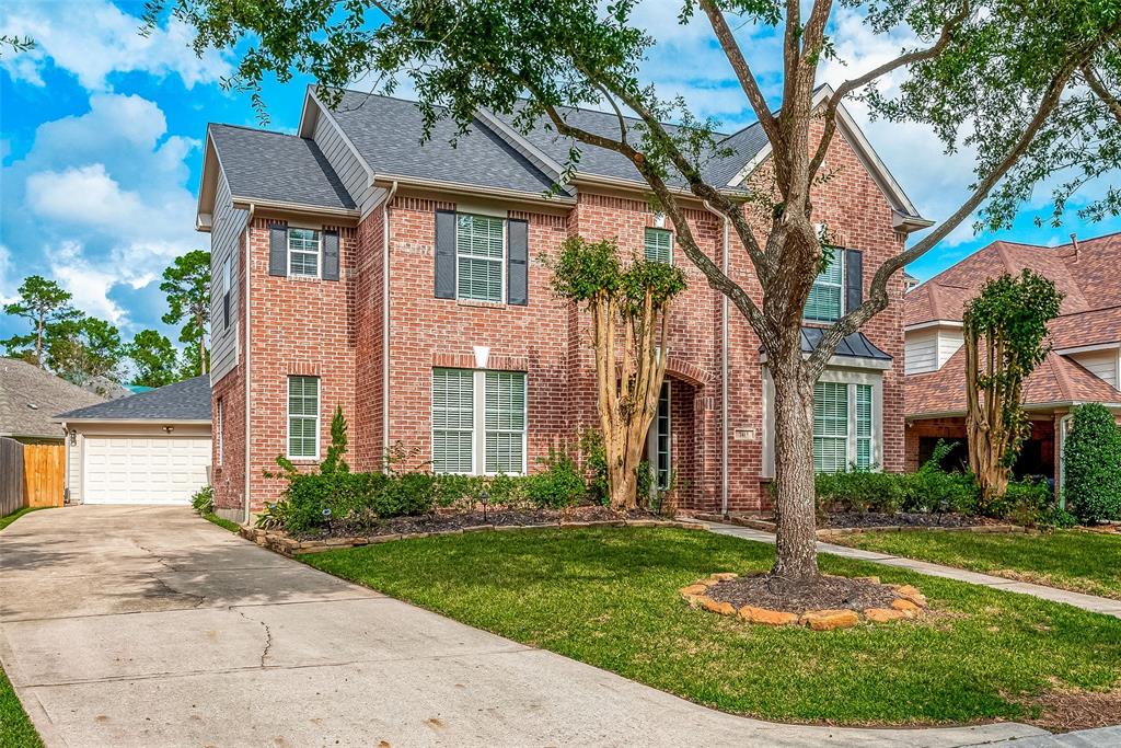 A real classic! Two-story red brick home with detached garage.