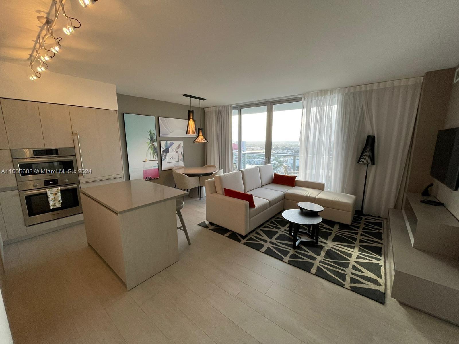 a living room with furniture fireplace and flat screen tv