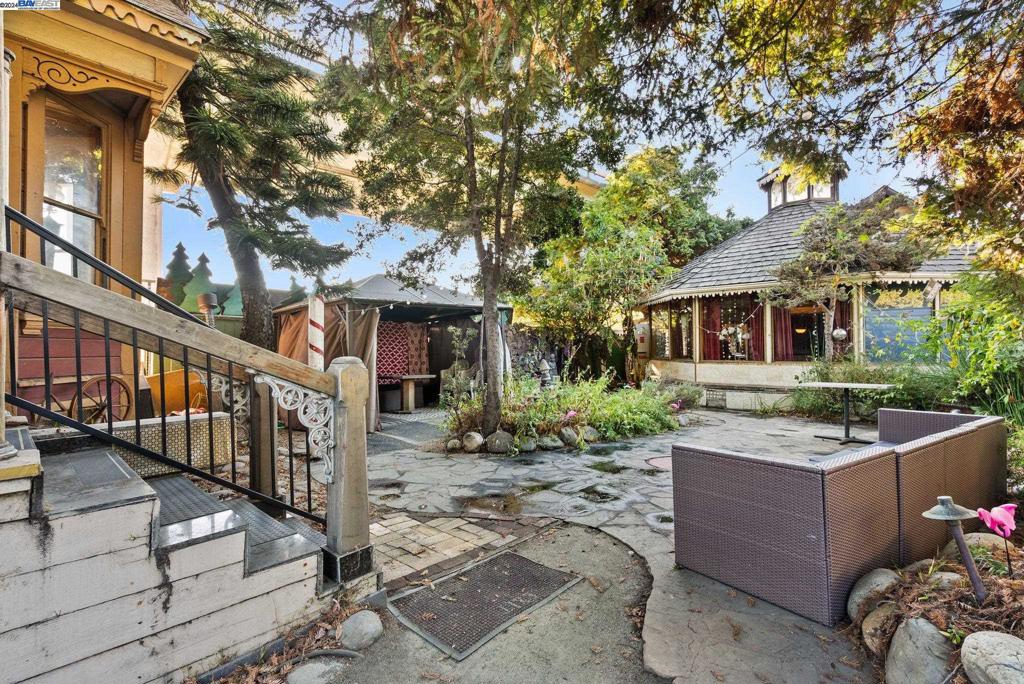 a view of a house with a tree and wooden fence