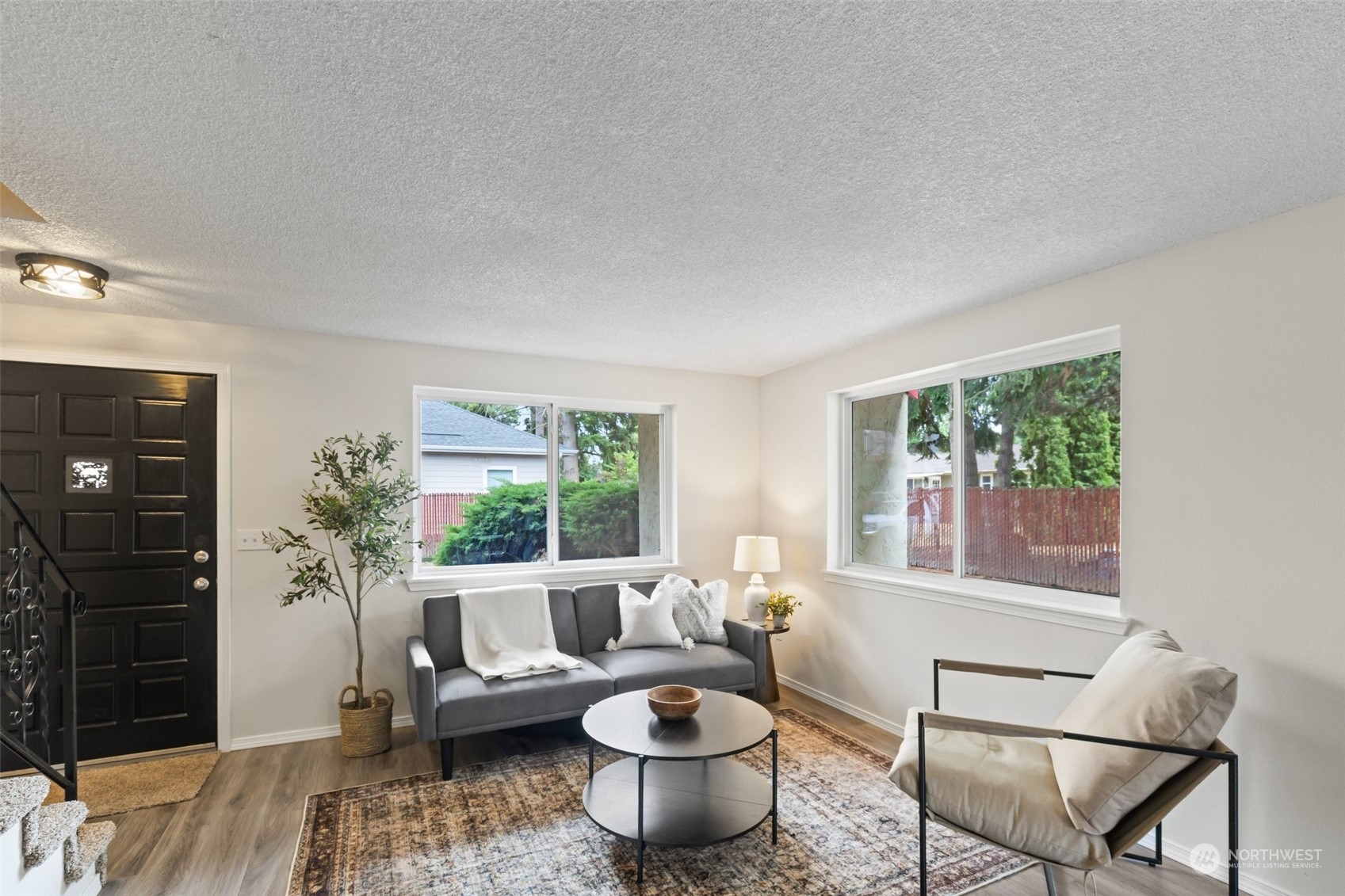 a living room with furniture and a potted plant