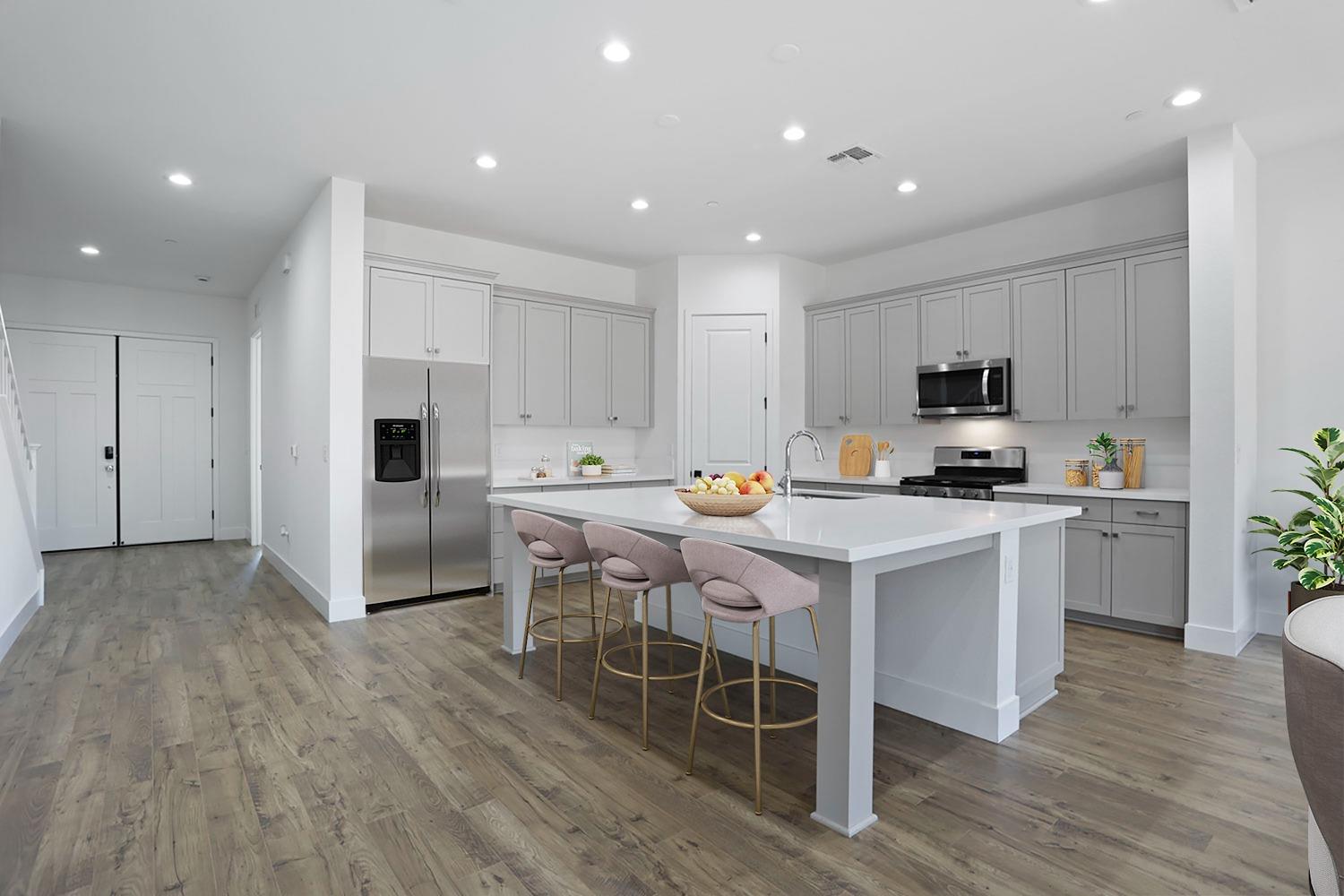 a kitchen with a sink a microwave a refrigerator and cabinets