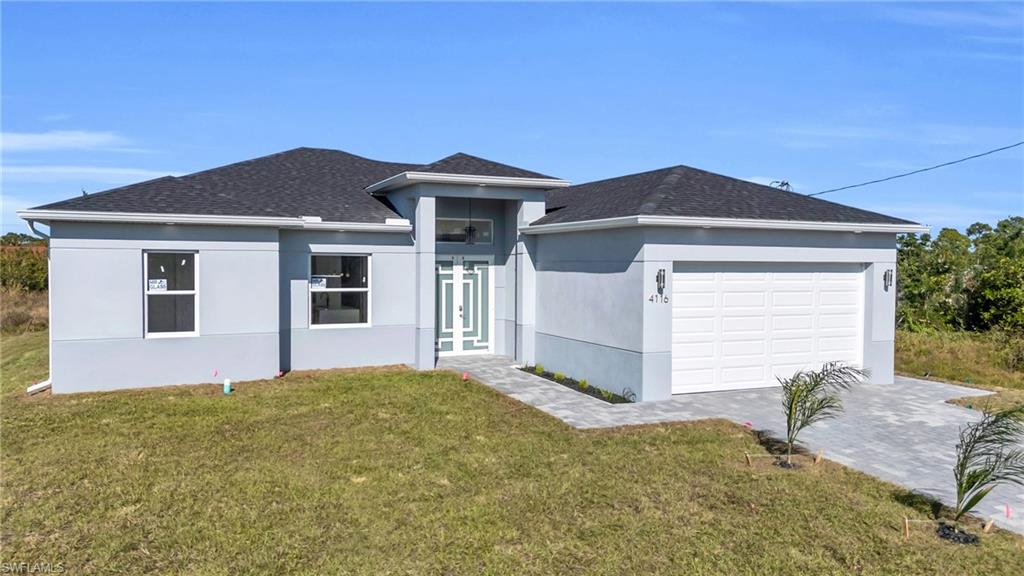 a front view of a house with a yard and garage