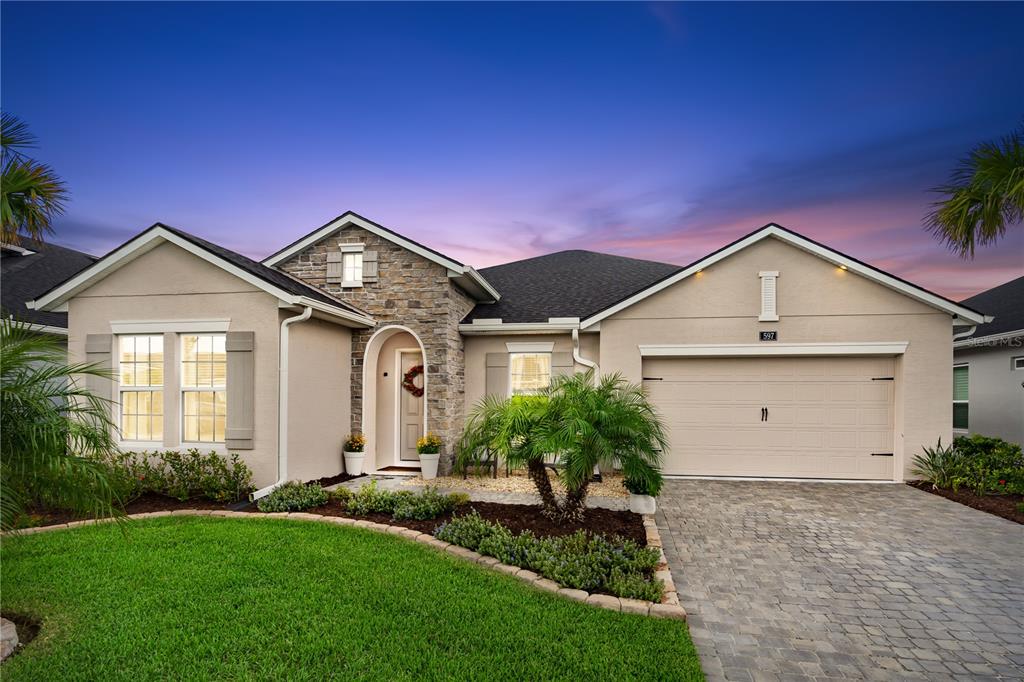 a front view of a house with a yard and garage