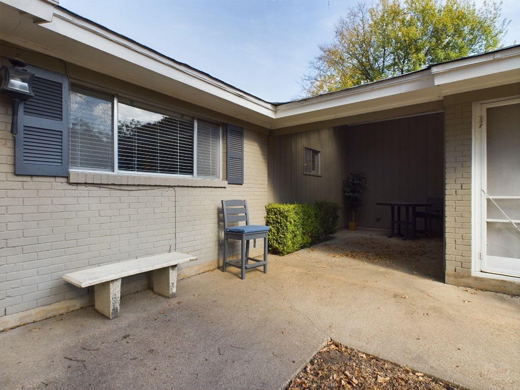 a view of backyard with a chair and table