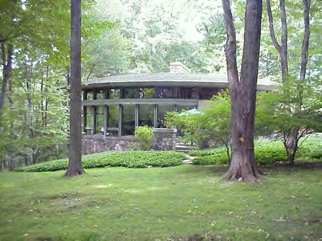 a view of a house with backyard and a sitting area