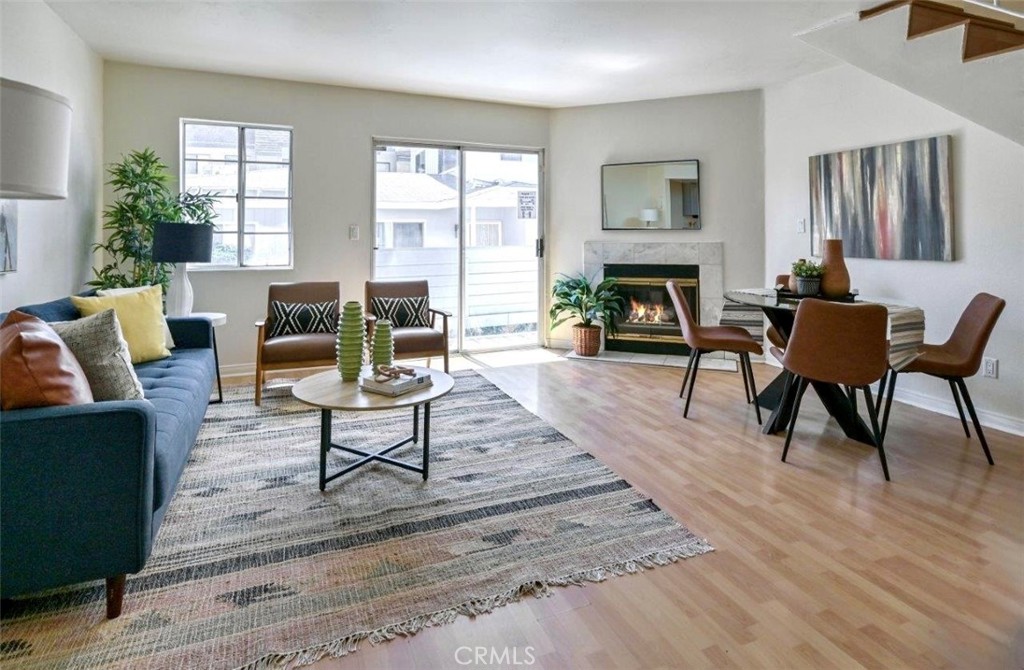 a living room with furniture a fireplace and a table