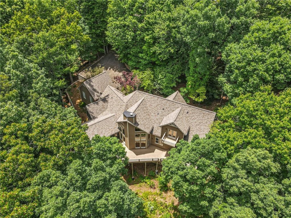 an aerial view of a house with a yard and trees