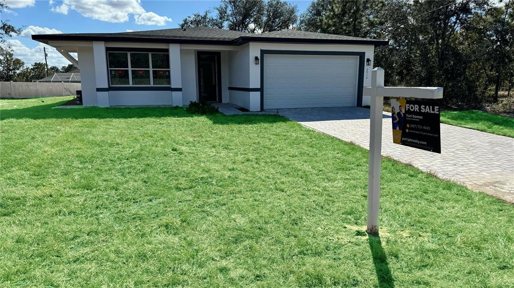 a view of an house with backyard space and garden