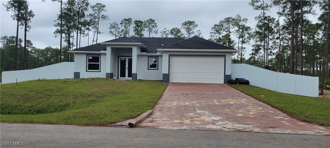 a front view of a house with a yard and garage