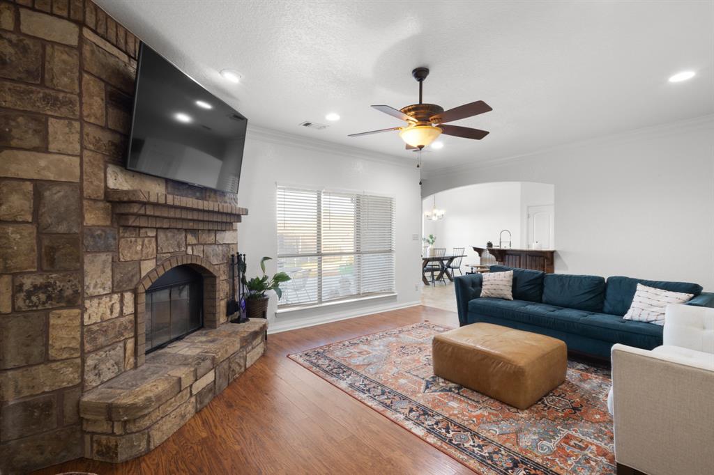 a living room with furniture a fireplace and a chandelier