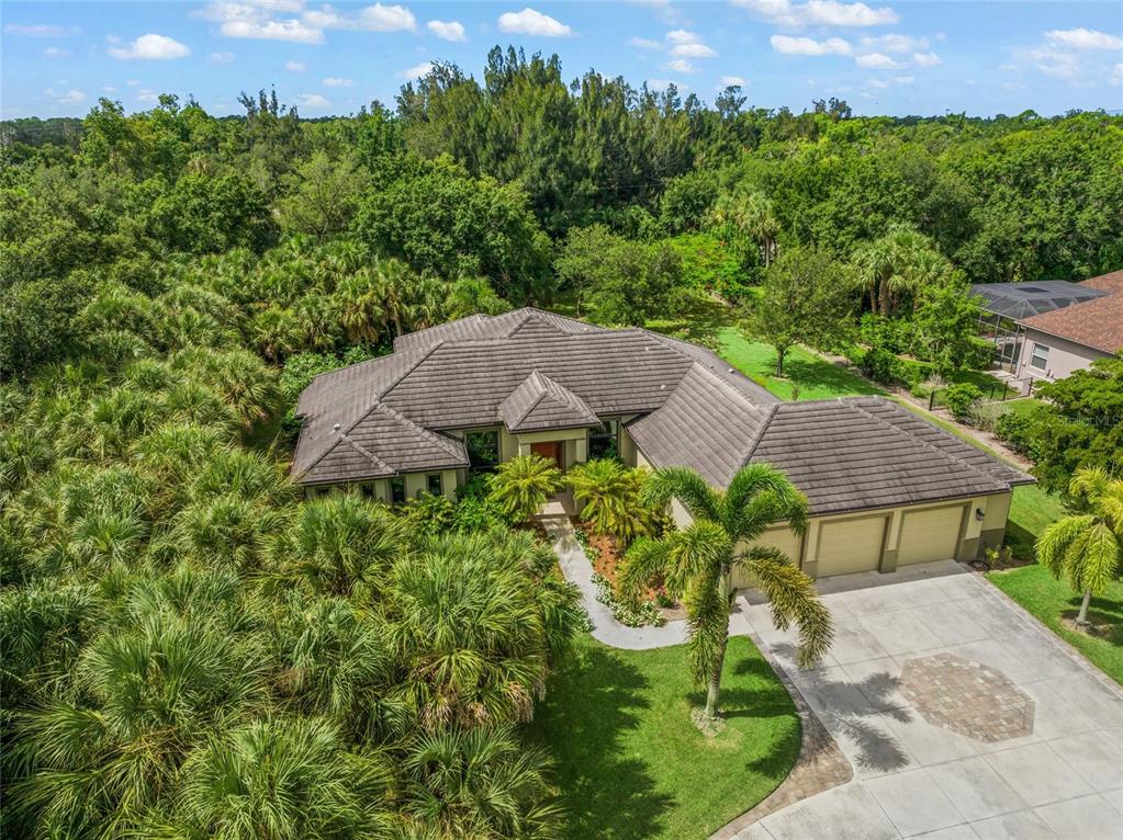 an aerial view of a house with yard and outdoor seating