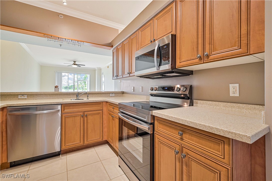 a kitchen with stainless steel appliances granite countertop a sink and dishwasher a stove top oven with wooden floor