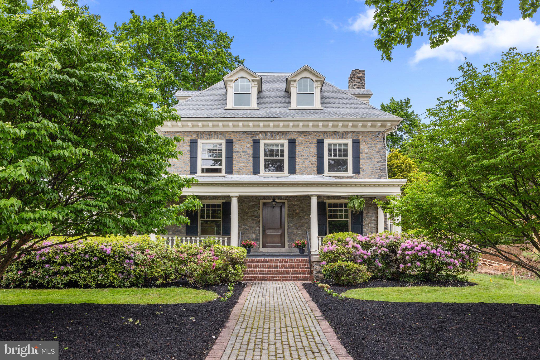 a front view of a house with a garden