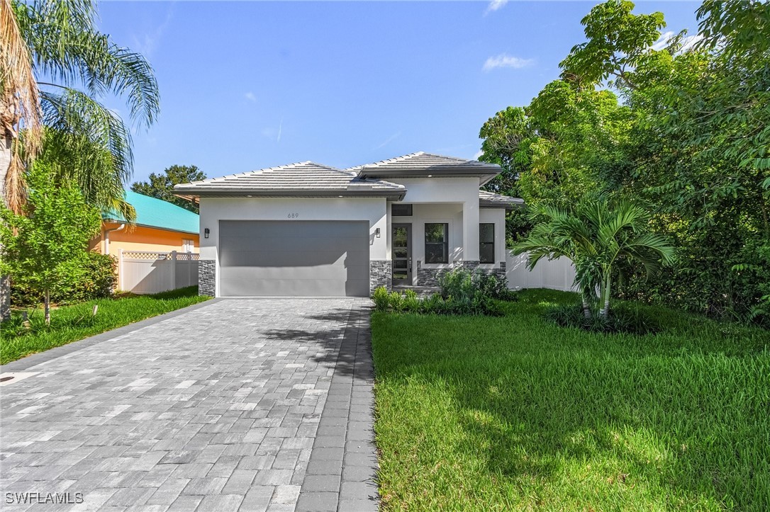 a front view of a house with garden