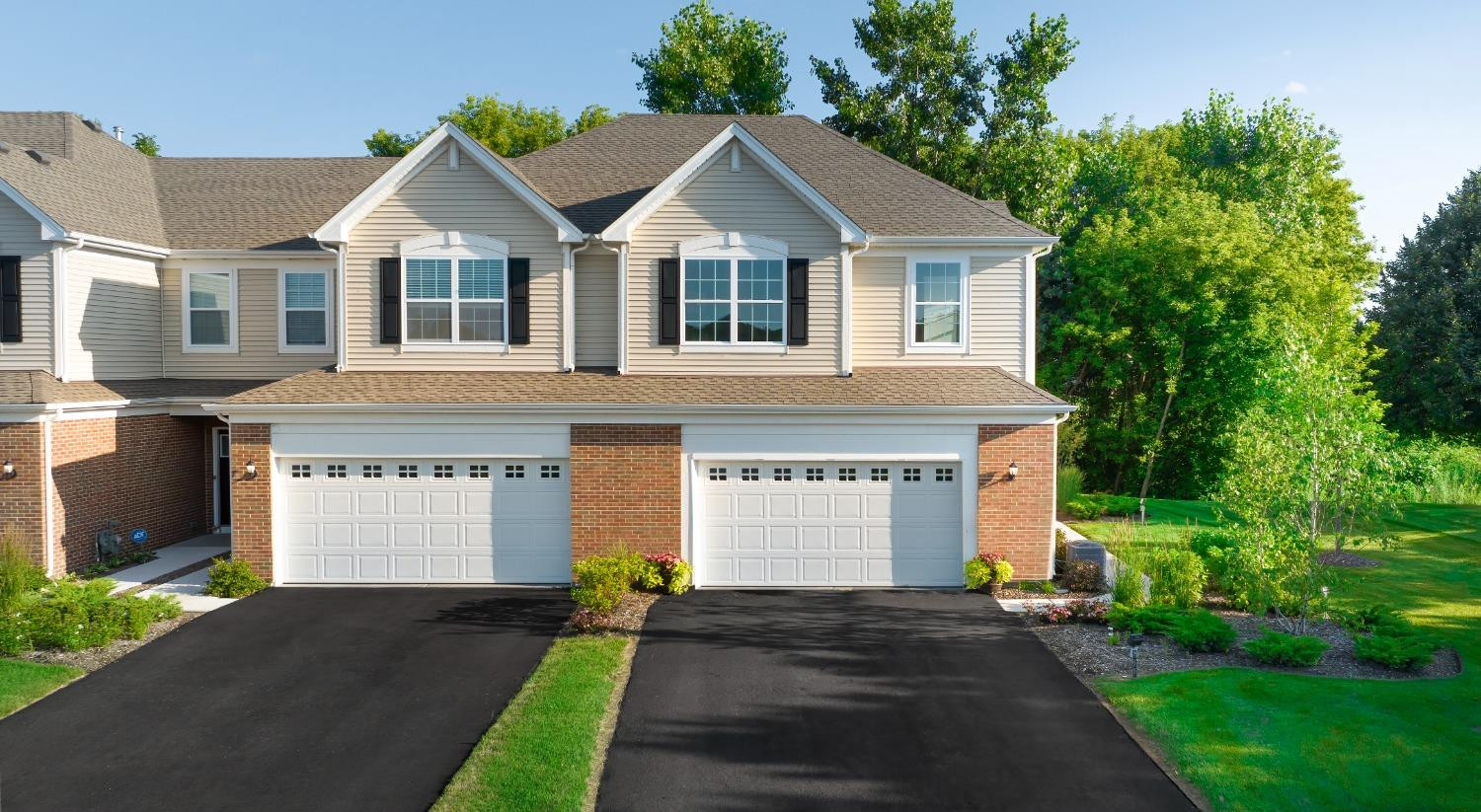 a front view of a house with a yard and garage