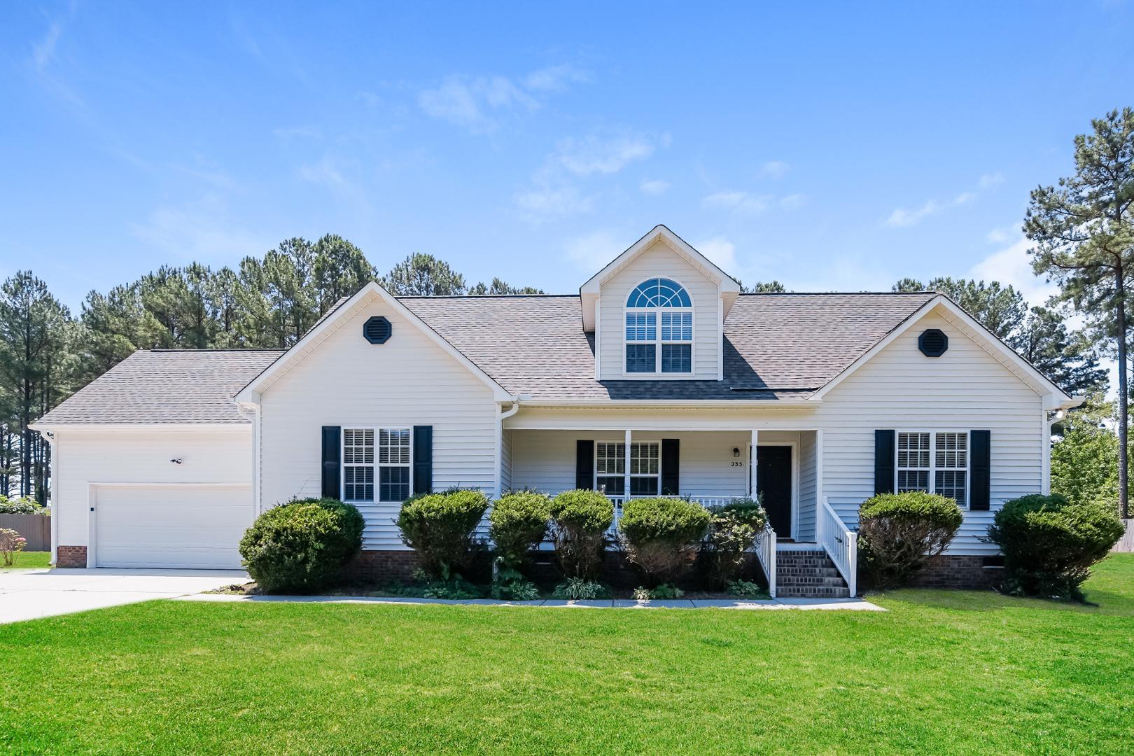 a front view of a house with a yard