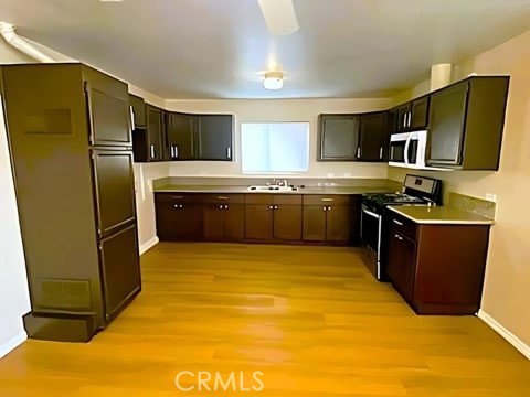 a large kitchen with stainless steel appliances granite countertop a refrigerator and a stove