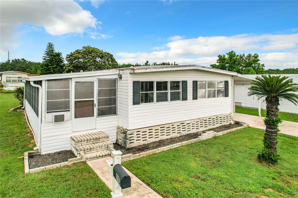 a view of a house with a yard